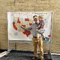Student and son in front of map